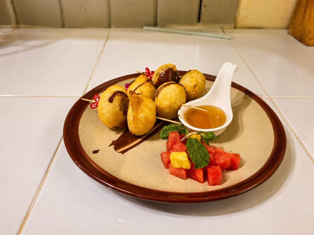 Banana fritters with honey and ice cream at WonderlanD