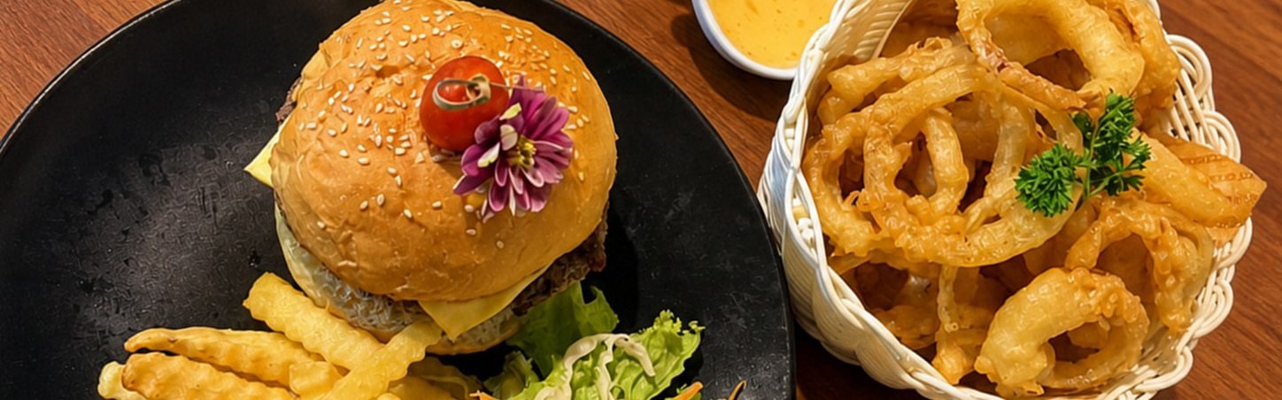 Cheeseburger with fries and a basket of onion rings at WonderlanD, Bang Niang