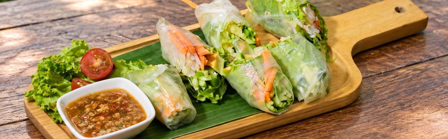 Fresh Vietnamese spring rolls with dipping sauce on a garden table at WonderlanD, Khao Lak