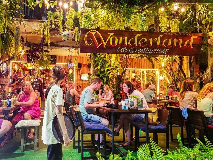 Guests under the WonderlanD sign in the garden