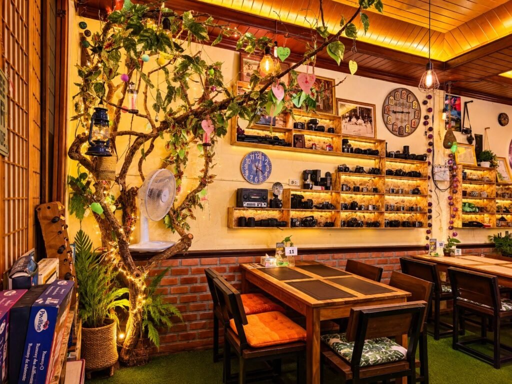 Dining tables beneath the vintage camera collection at WonderlanD Bar and Restaurant, Khao Lak